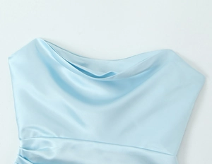 Detailed view of light blue satin dress featuring a soft cowl neckline and glossy fabric