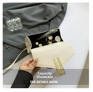 Detail view of the beige crossbody bag interior with smartphone and makeup essentials