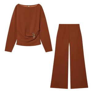 Detail of caramel off-shoulder top and wide-leg trousers set in premium knit fabric