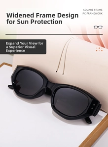 Detail shot of wide black square sunglasses with metal rivets on a leather bag