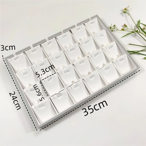 Detailed view of 24-slot jewelry display tray for necklaces and pendants in grey and white
