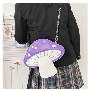 Detail view of purple mushroom shaped shoulder bag with white polka dots on a model