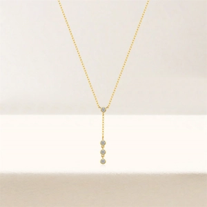 Detailed view of S925 silver Y-shaped gold necklace with four vertical white zircons
