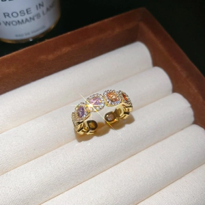 Macro shot of 14k gold plated open ring featuring multi-color stones in a jewelry box