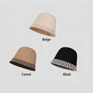 Three minimalist knit bucket hats in beige, camel, and black with striped brim detailing
