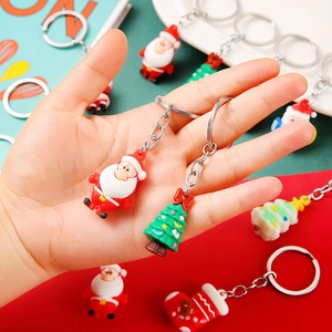 Christmas themed keychain set with Santa, tree and sock charms held in hand