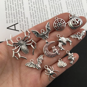 Detailed view of silver Halloween charms including spiders and pumpkins for DIY jewelry