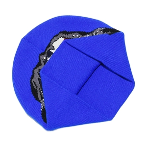 Close-up of royal blue beanie featuring a shark mouth pattern in streetwear style