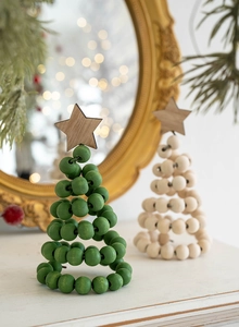 Detail of Nordic wooden bead Christmas tree ornaments on white surface with festive bokeh