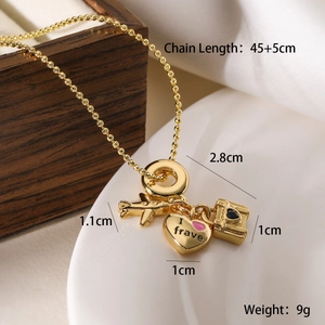 Macro shot of 18K gold plated airplane heart and suitcase charms on a gold chain