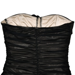 Close-up of black mesh back detail with horizontal pleats and light beige lining