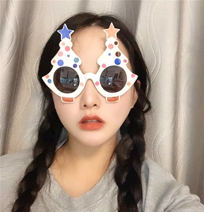 Detail of a white Christmas tree glasses frame with colorful polka dots on a female model