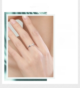 Detail of s925 silver ring featuring marquise zircon and blue accent stone on finger