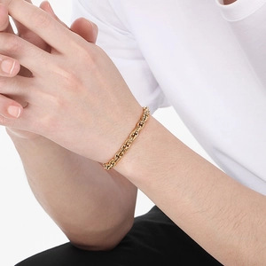 Close-up of men's chunky 18K gold plated stainless steel twisted rope chain bracelet