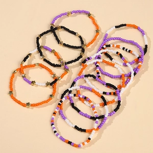 Detail of colorful Halloween beaded bracelets with orange, purple, and gold star charms