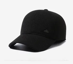 Detail of winter baseball cap with side metal logo and warm thick twill fabric texture