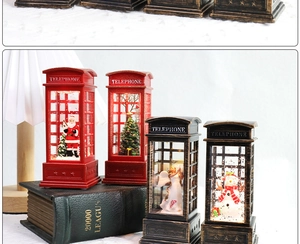 Macro shot of retro Christmas telephone booth lanterns with glowing Santa figurines