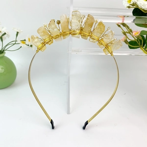 Detailed macro view of handmade gold wire crown headband with raw citrine and pearls
