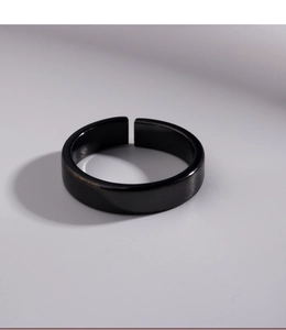 Detail view of the sleek black adjustable ring showcasing polished minimalist finish
