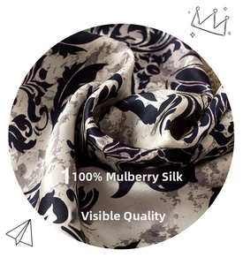 Close-up of 100% mulberry silk fabric with elegant baroque patterns and satin luster