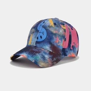 Detail of baseball cap with blue tie-dye star pattern and colorful graffiti smile prints