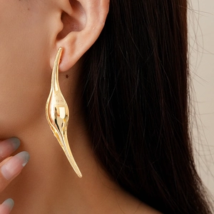 Dramatic irregular gold leaf earrings with organic flowing lines for a stylish look