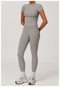 Macro shot of moisture-wicking smoke grey yoga set featuring seamless short sleeve top