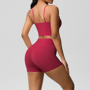 Detail of burgundy backless yoga set featuring thin straps and high-waisted gym shorts