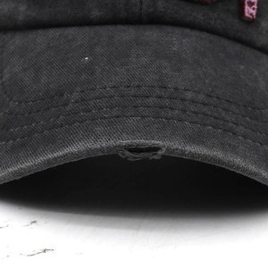 Macro shot of distressed brim details on a washed gray vintage 1981 embroidery cap