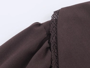 Detailed macro view of coffee brown top with delicate lace trim and plain weave fabric