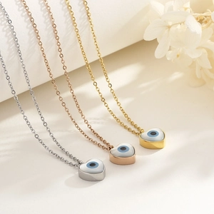Three heart-shaped Evil Eye pendant necklaces in gold, silver, and rose gold finish