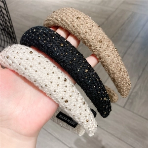 Macro shot of handmade tweed headbands with rhinestones in beige, black and khaki