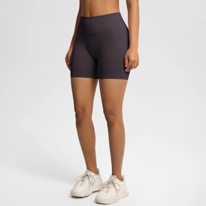 Close-up of wide high-waisted seamless waistband on dark purple yoga shorts for tummy support