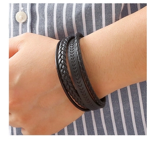 Close-up of multilayer black braided leather bracelet for men with textured details