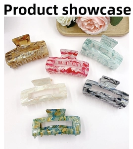 Flat lay of marble texture acrylic hair claws in six different colors and patterns