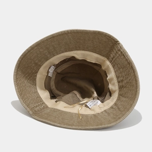 Detailed interior of khaki cotton bucket hat showing sweatband and adjustable drawstring