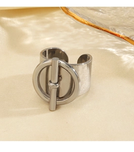 Macro detail of silver OT buckle style wide open ring on elegant silk background