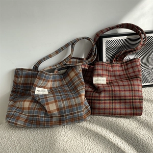 Detail of vintage wool plaid tote bags in blue-brown and red-brown checkered patterns
