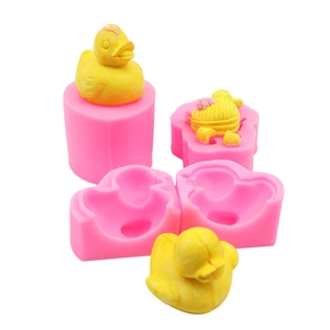 Macro detail of flexible pink silicone mold showing 3D little yellow duck cavity design