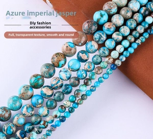 Detailed view of polished blue imperial jasper beads showing natural marble textures