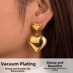 Detail of vintage gold heart earrings with vacuum plating and high mirror shine