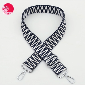 Detail of adjustable woven canvas strap with navy blue wave pattern and silver metal clips