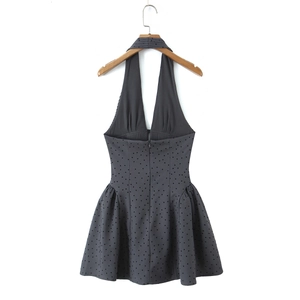 Detail of grey halter mini dress featuring black polka dots and an invisible back zipper