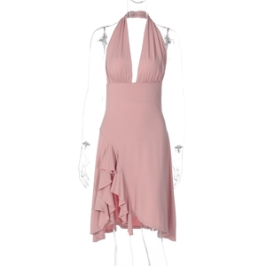 Detail of pink halter neck dress featuring deep V-neckline and ruffled asymmetric hemline