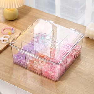 Clear acrylic storage box with 9 compartments and lid containing colorful beads