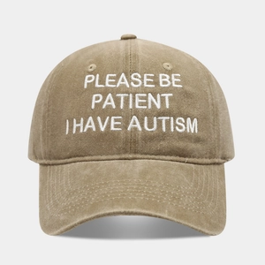 Detail of khaki cotton baseball cap with embroidered PLEASE BE PATIENT I HAVE AUTISM text