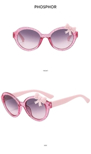Detailed front and side view of pink glitter kids bow sunglasses with gradient lenses