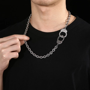 Detailed view of silver stainless steel O-chain necklace with a handcuff pendant charm