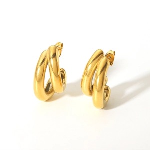 Macro detail of intertwined 18K gold plated stainless steel hoops with high polish finish