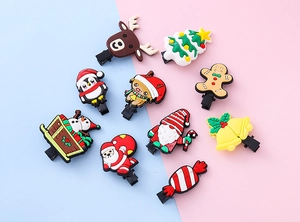 Flat lay of colorful Christmas themed hair clips with Santa and reindeer designs